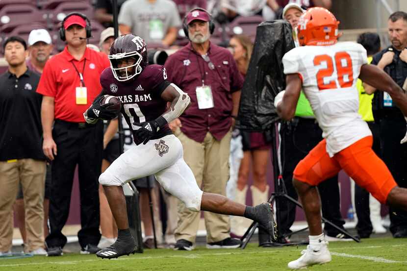 Texas A&M wide receiver Ainias Smith (0) runs down the sideline after catching a pass to...
