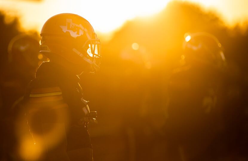 Lancaster players warm up before a District 6-5A Division I high school football game...