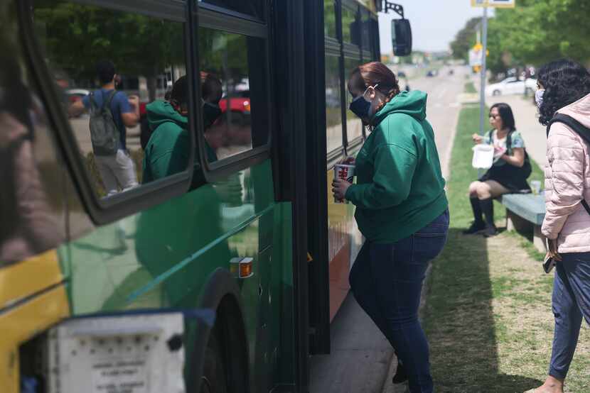 People get on a DART bus on Tuesday, April 19, 2022 at University of Texas Dallas in...