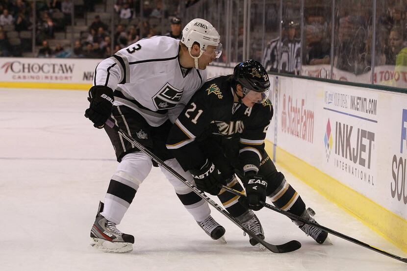 Anaheim Ducks defenseman Francois Beauchemin, back, knocks down Dallas Stars left wing Loui...