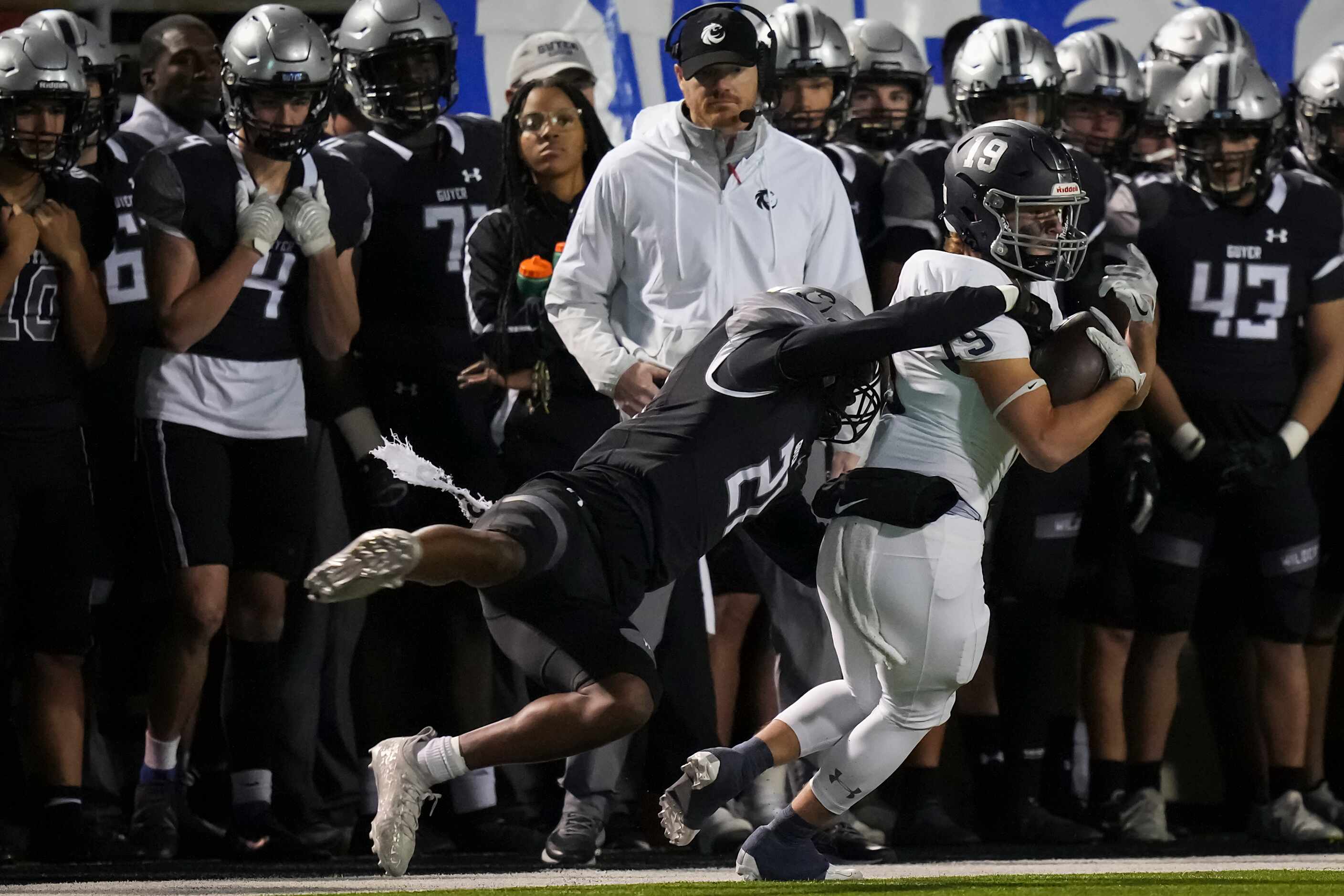 Flower Mound wide receiver Cade Edlein (19) is knocked out of bounds by Denton Guyer...
