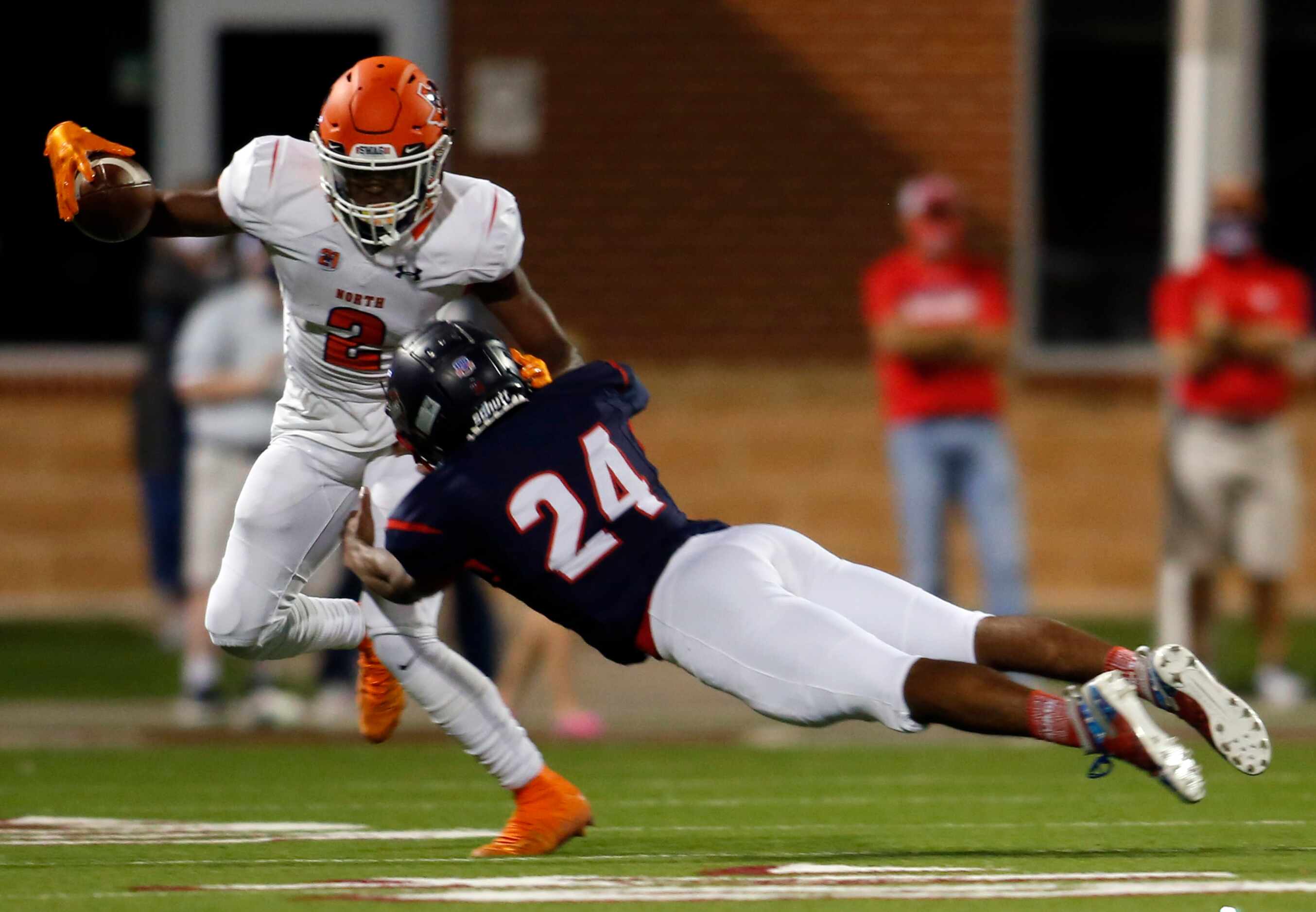 McKinney North receiver JJ Henry (2) makes a jump cut in an attempt to avoid the flying...