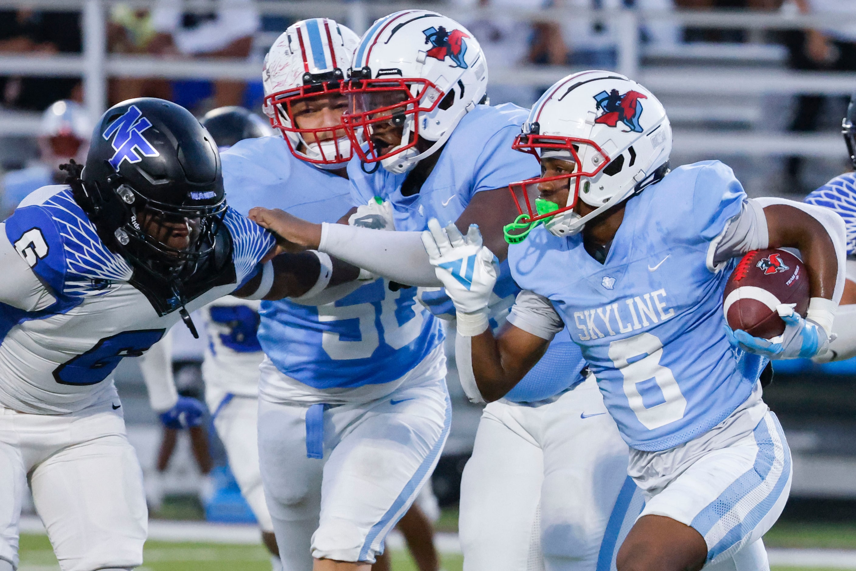 Skyline High’s Tyreke Cockroft (8) runs for a yardage as North Forney High’s J’ynv Williams...