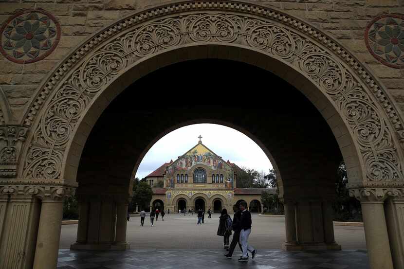 Students and visitors walk on the Stanford University campus on March 12 in Stanford, Calif. 