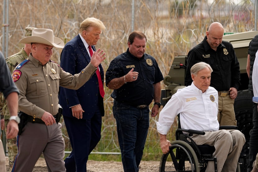 Republican presidential candidate Donald Trump talks with, from left, Freeman Martin, deputy...