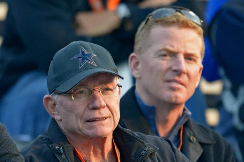 Dallas Cowboys owner Jerry Jones looks over the action with Cowboys coach Jason Garrett,...