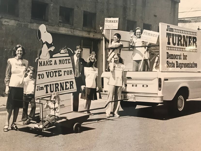 A young John Turner (left) rides a float pushing support for his father's campaign for state...