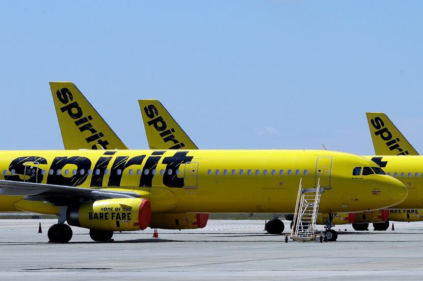 A line of Spirit Airlines jets sit on the tarmac at Orlando International Airport in 2020 in...