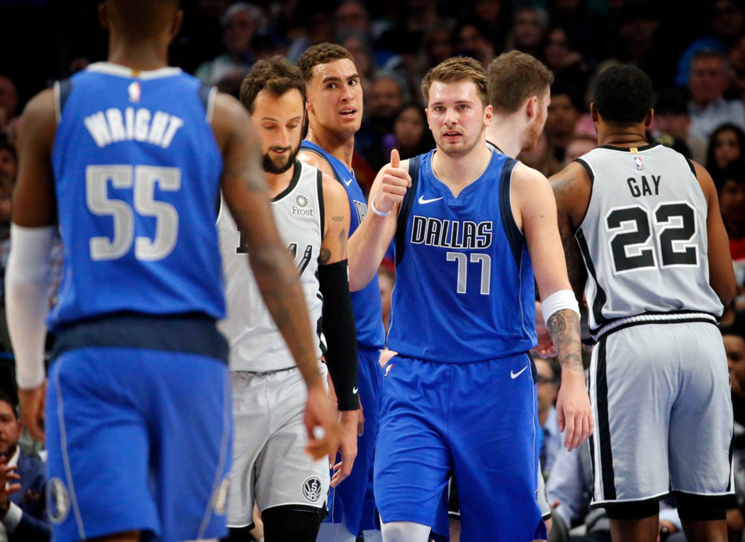 Dallas Mavericks forward Luka Doncic (77) gives the thumbs up to guard Delon Wright (55)...