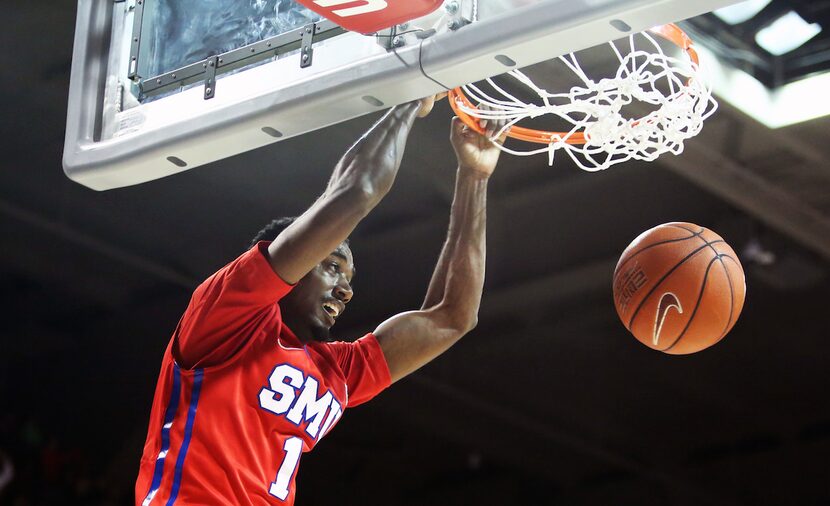  Ryan Manuel dunks the ball during the second half of an NCAA basketball game between the...