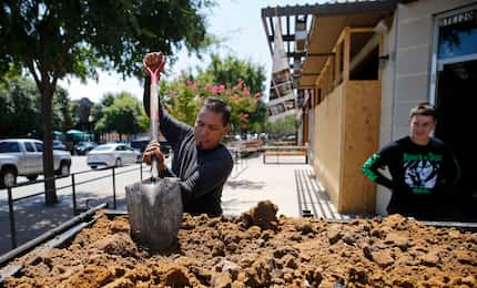 Lino Pompa evens works at 2023 Greenville Ave., as his son Alex Pompa watches. This...