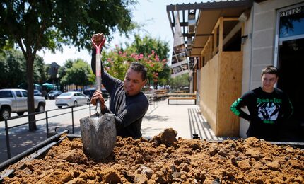 Lino Pompa evens works at 2023 Greenville Ave., as his son Alex Pompa watches. This...