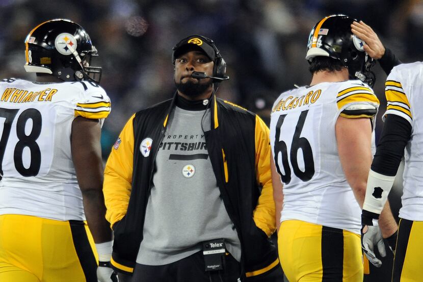 FILE - In this Nov. 28, 2013 file photo, Pittsburgh Steelers coach Mike Tomlin stands on the...