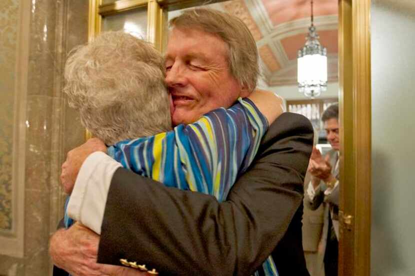
UT President Bill Powers embraced Martha F. Hilley of the faculty council after he learned...