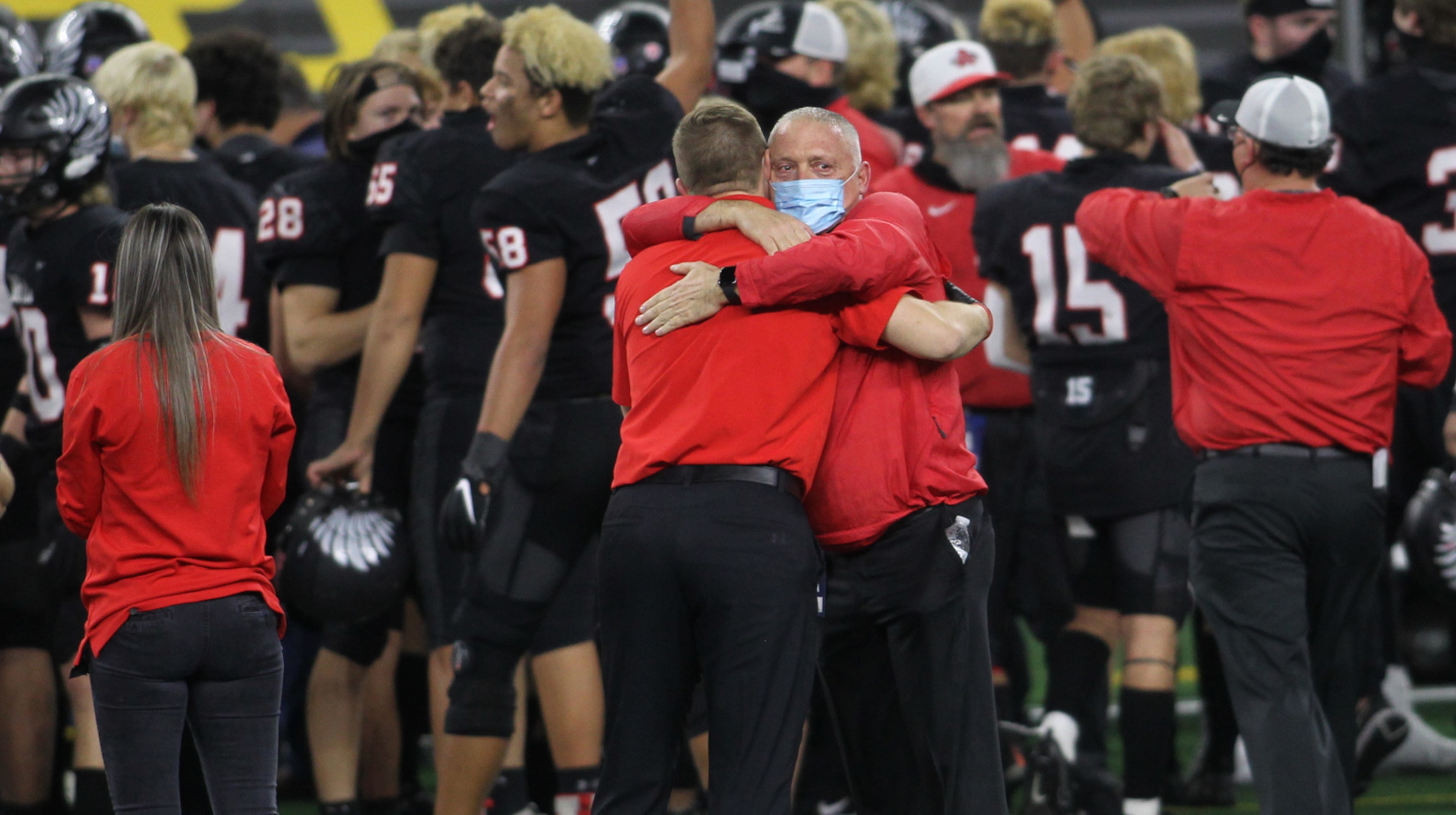 Argyle head coach Todd Rodgers receives a congratulatory hug near the team bench following...