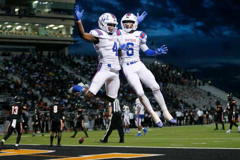 Duncanville wide receiver Christopher Thompson (4) is congratulated by his teammate...