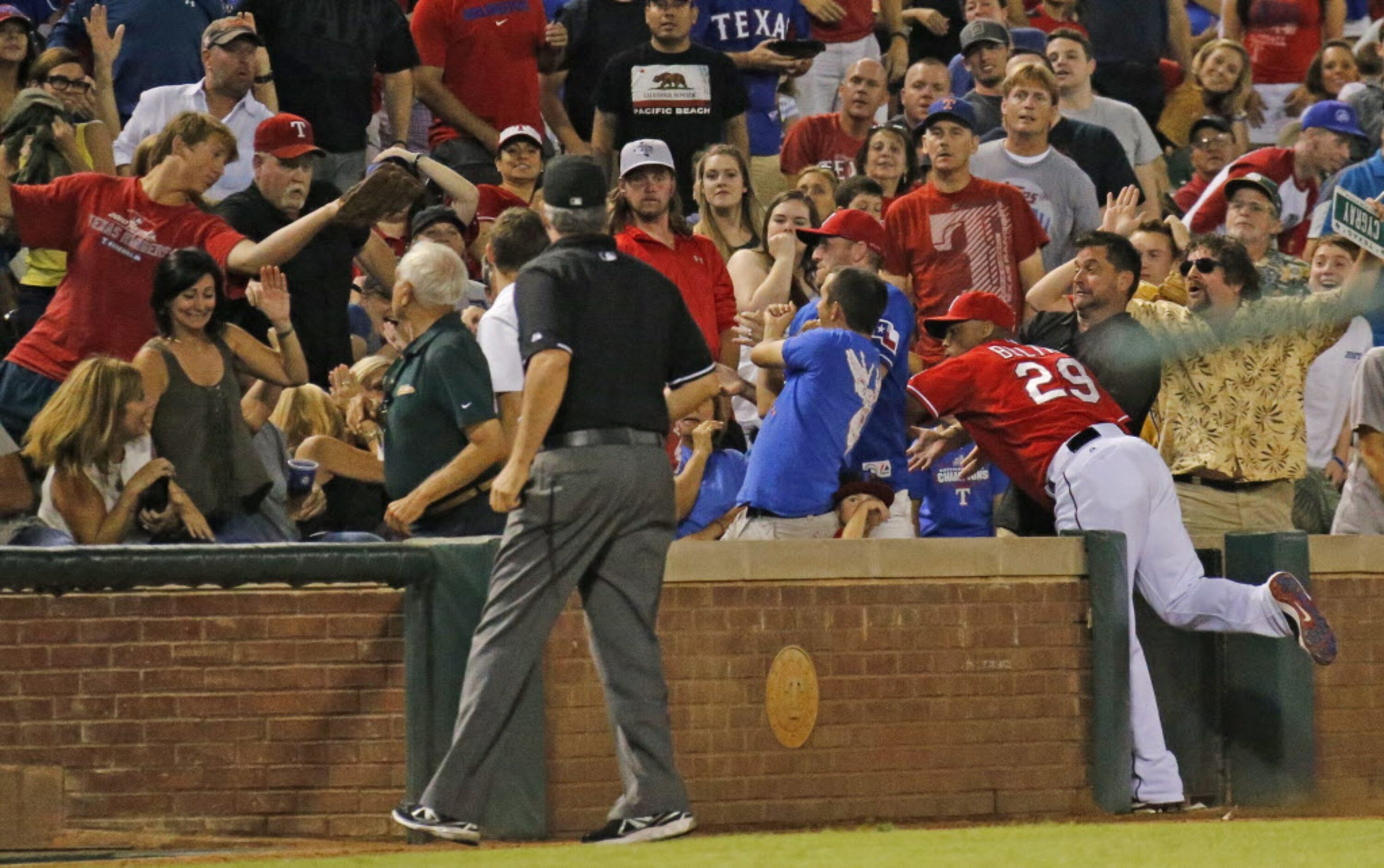 Texas third baseman Adrian Beltre tries in vain to get to an eighth-inning foul pop fly down...