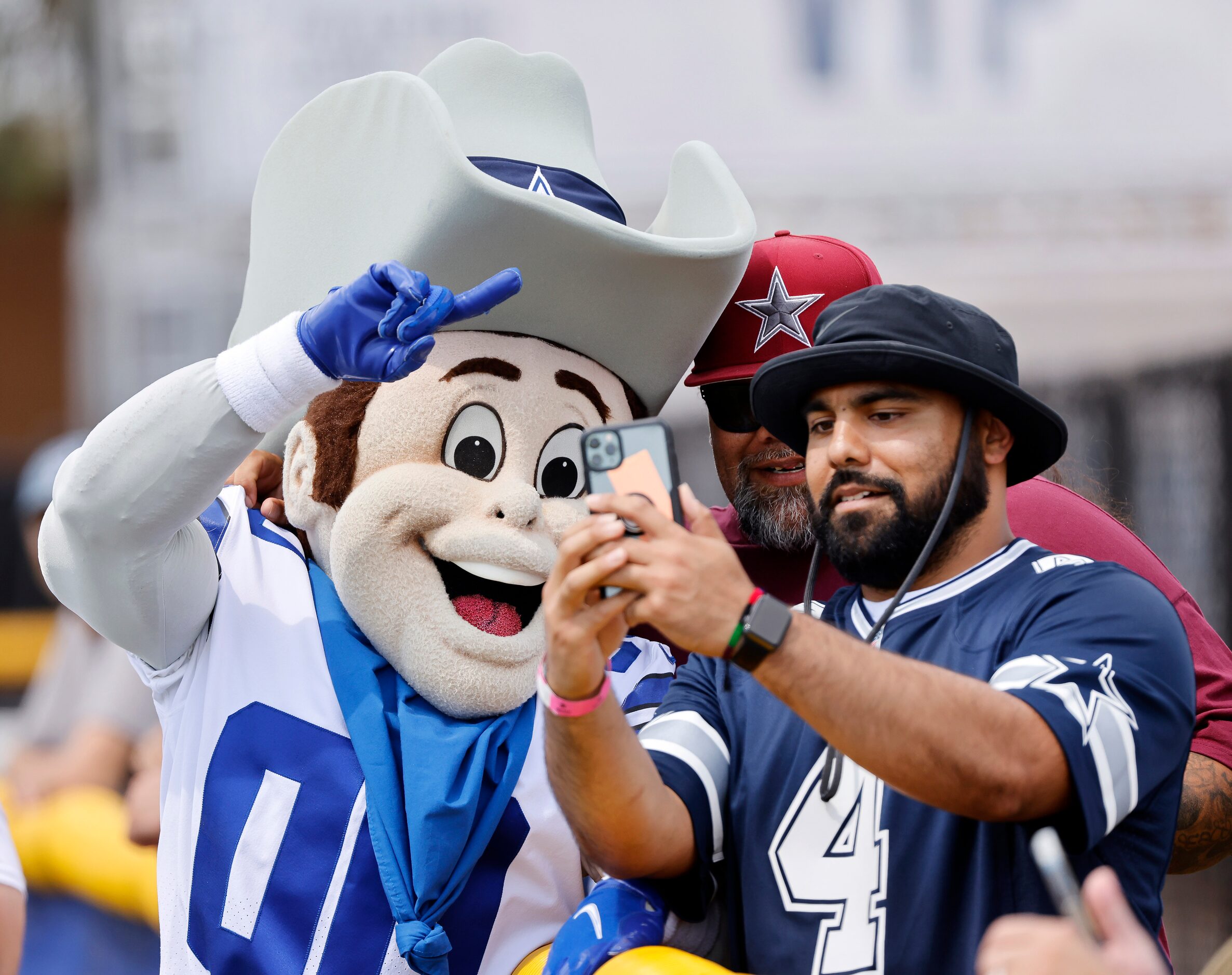 Dallas Cowboys mascot, Rowdy, poses for a photo with fans Jesse Ochoa (center) and Jesse...