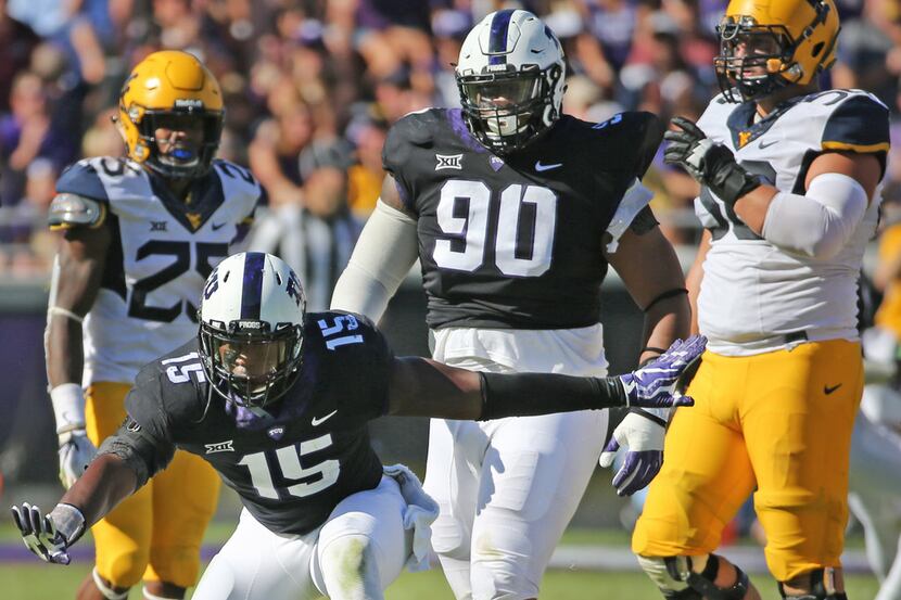 TCU defensive end Ben Banogu (15) celebrates sacking West Virginia quarterback Will Grier...