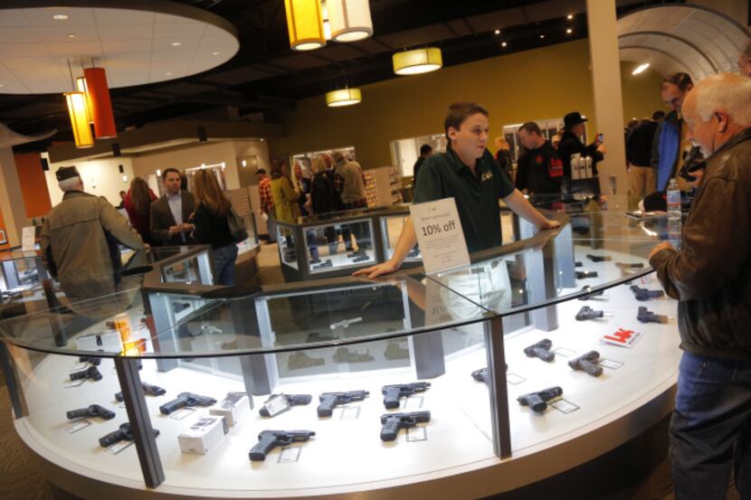 Clay Hunn worked at the handgun desk at the Frisco Gun Club on Friday at the club's grand...