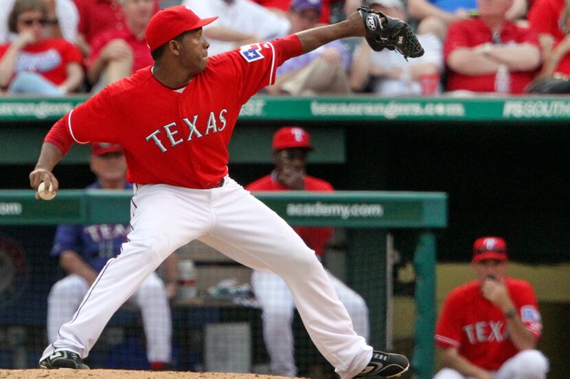Texas closer Neftali Feliz fires a ninth-inning pitch during Opening Day 2011 and the Boston...
