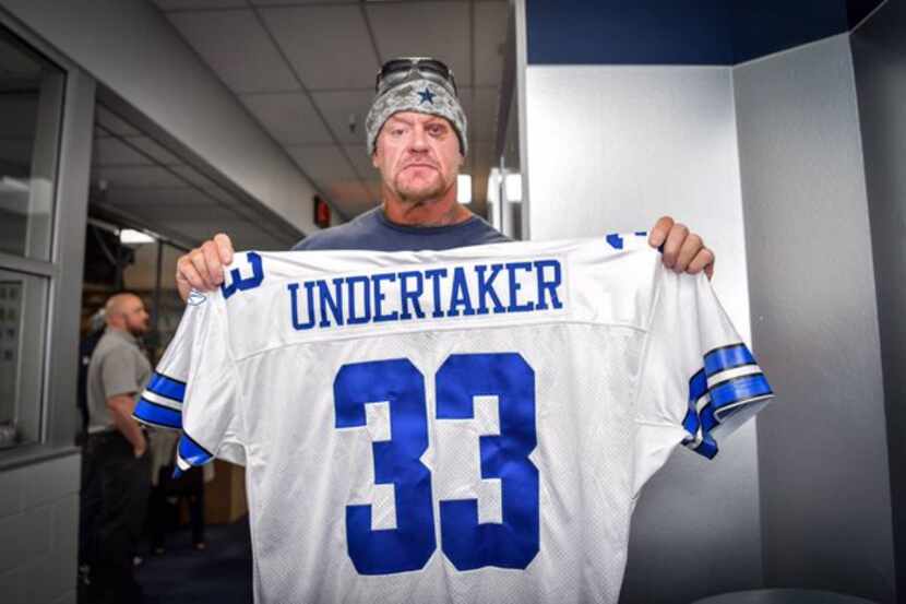 The Undertaker shows off his Cowboys jersey.
