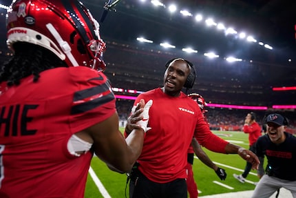 Houston Texans wide receiver John Metchie III, left, celebrates with head coach DeMeco Ryans...