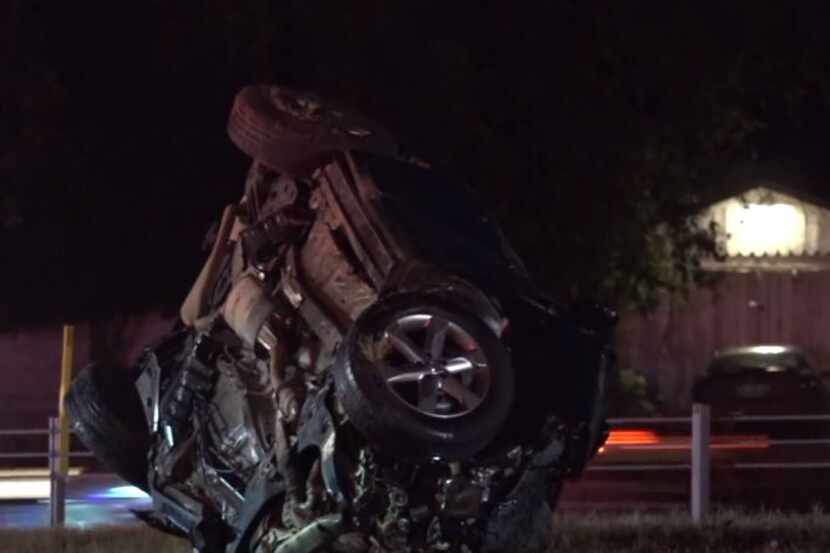An SUV lies overturned along Loop 820 after its driver was killed Wednesday morning in a...