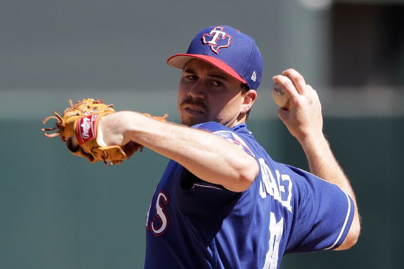 Texas Rangers' Chi Chi Gonzalez throws during the first inning of a spring training baseball...