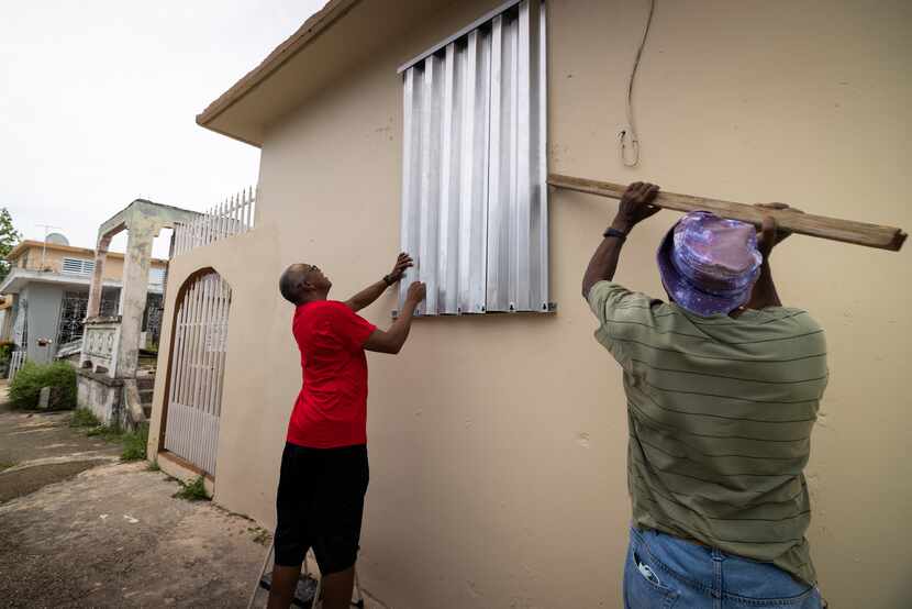 Residents prepare for the arrival of Tropical Storm Fiona, in Loiza, Puerto Rico, Saturday,...