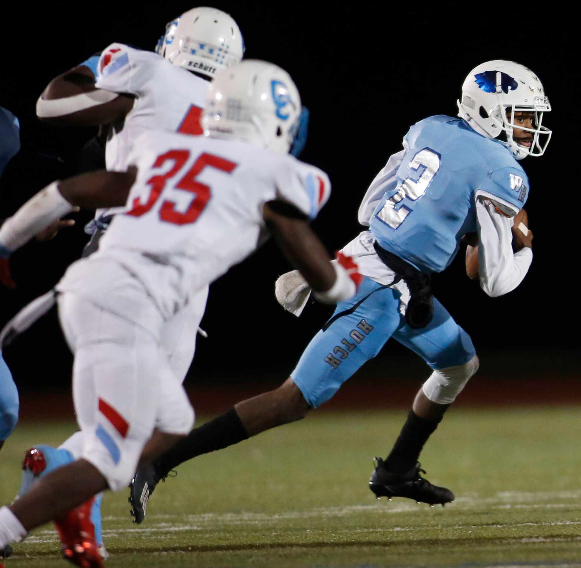 Wilmer Hutchins quarterback Kace Williams (2) rolls out of the pocket to avoid the defensive...
