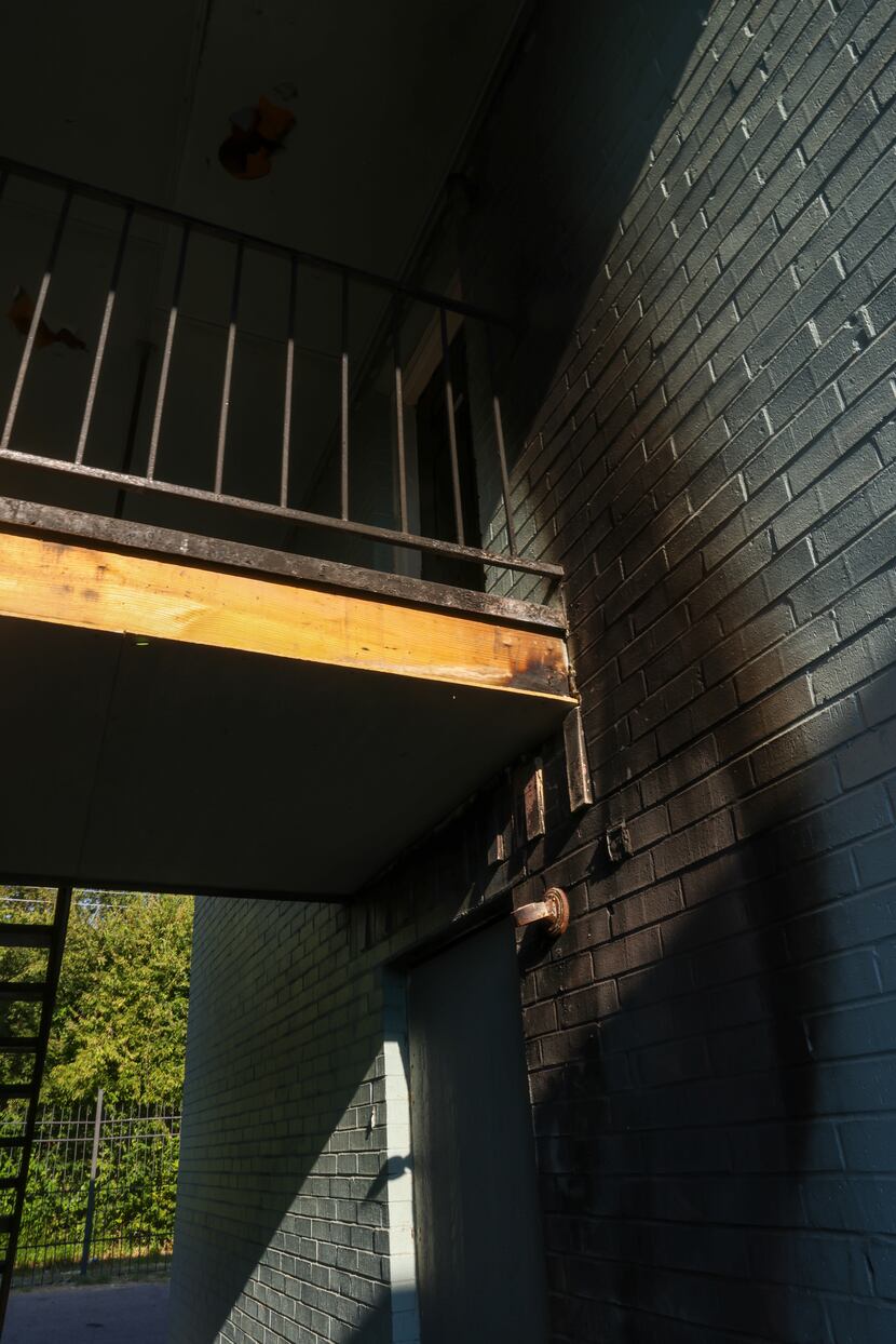 Scorch marks run along the side of an apartment building at Frances Place Apartments, a...