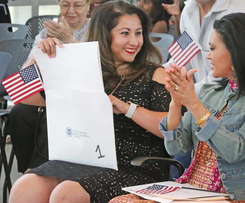 Karina Almaguer, from Ecuador, is all smiles after becoming an American citizen at a...