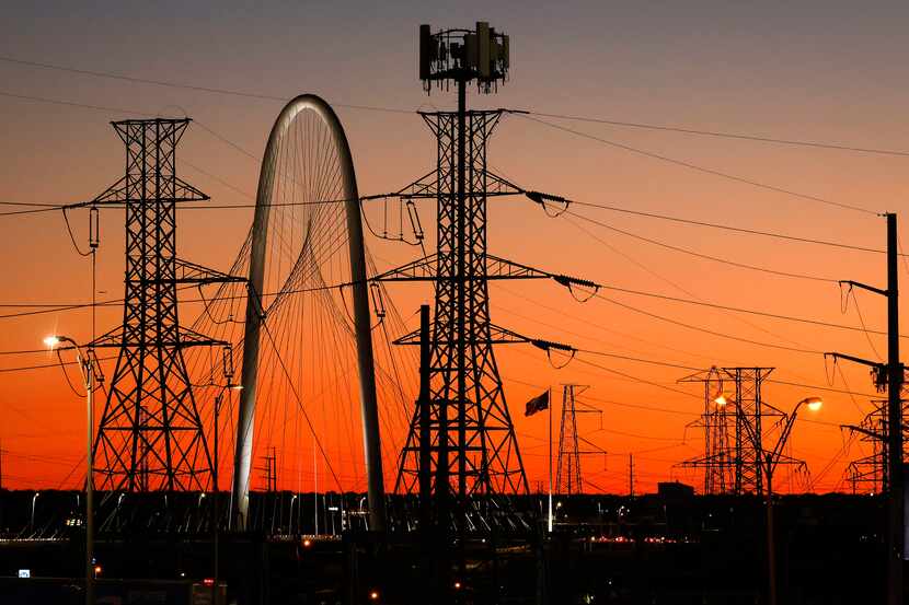 The Margaret Hunt Hill Bridge in Dallas is seen behind high transmission power lines running...