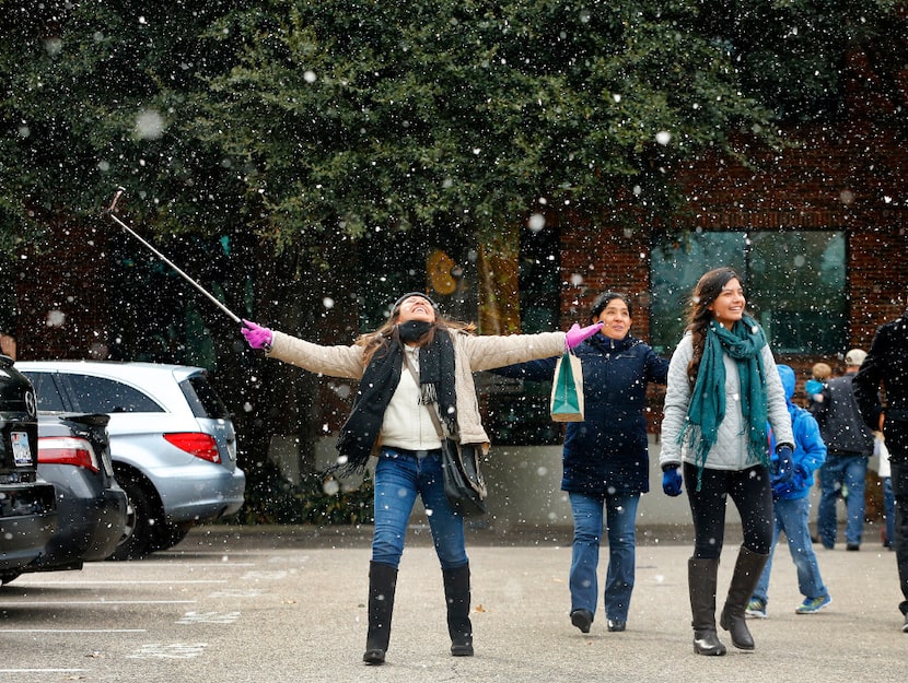 Visitors Yolotzin Ojeda of Guanajuato, Mexico (left) records herself playing in the snow on...