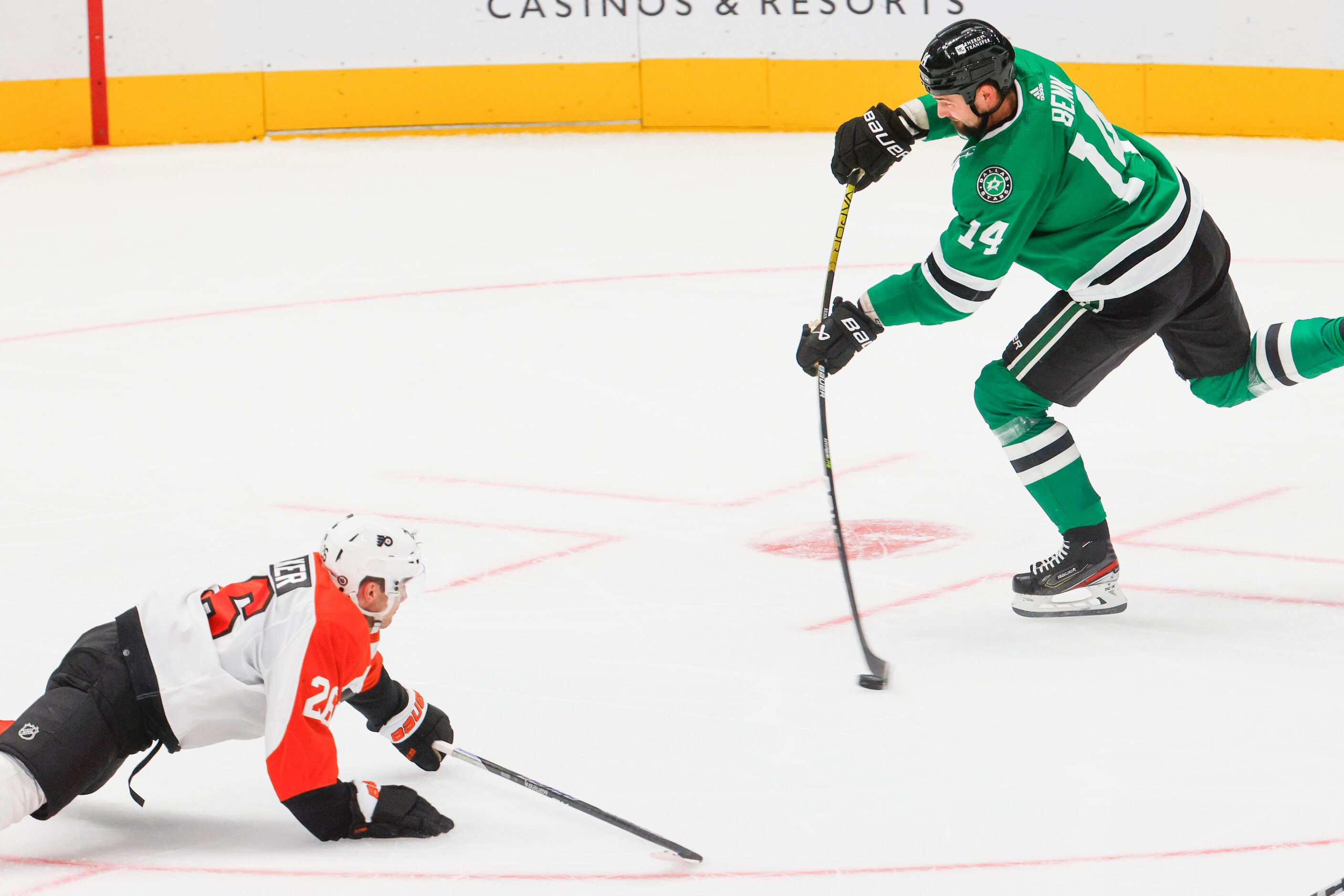 Dallas Stars left wing Jamie Benn (right) shoots for a goal past Philadelphia Flyers...