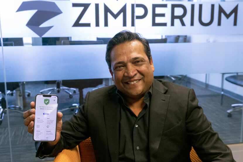 Zimperium CEO Shridhar Mittal holds his phone with the Dallas Secure app at the Zimperium...