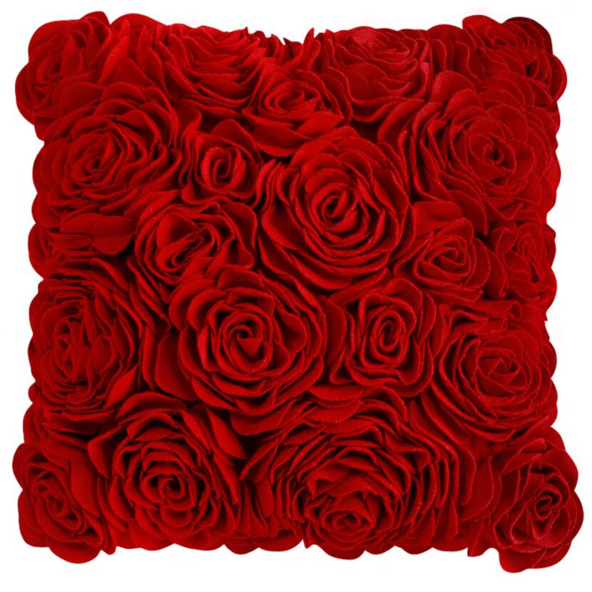 A delicate cluster of red, felt roses adorns a 16-inch square pillow. $39.95 at Pier 1...