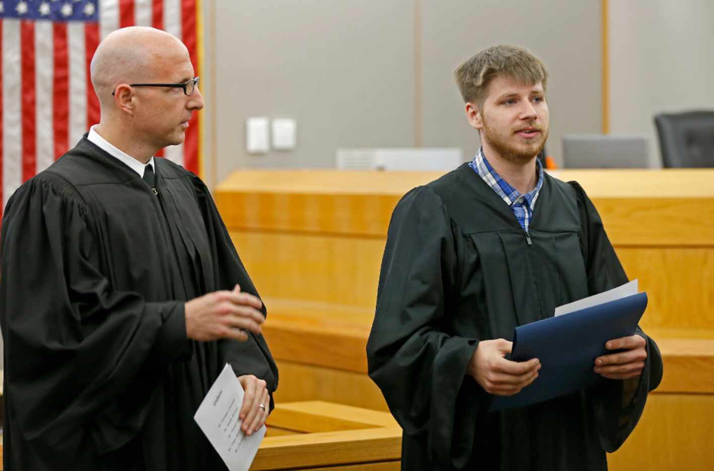 Charles Troutman (right) spoke next to Judge Brandon Birmingham during a graduation ceremony...