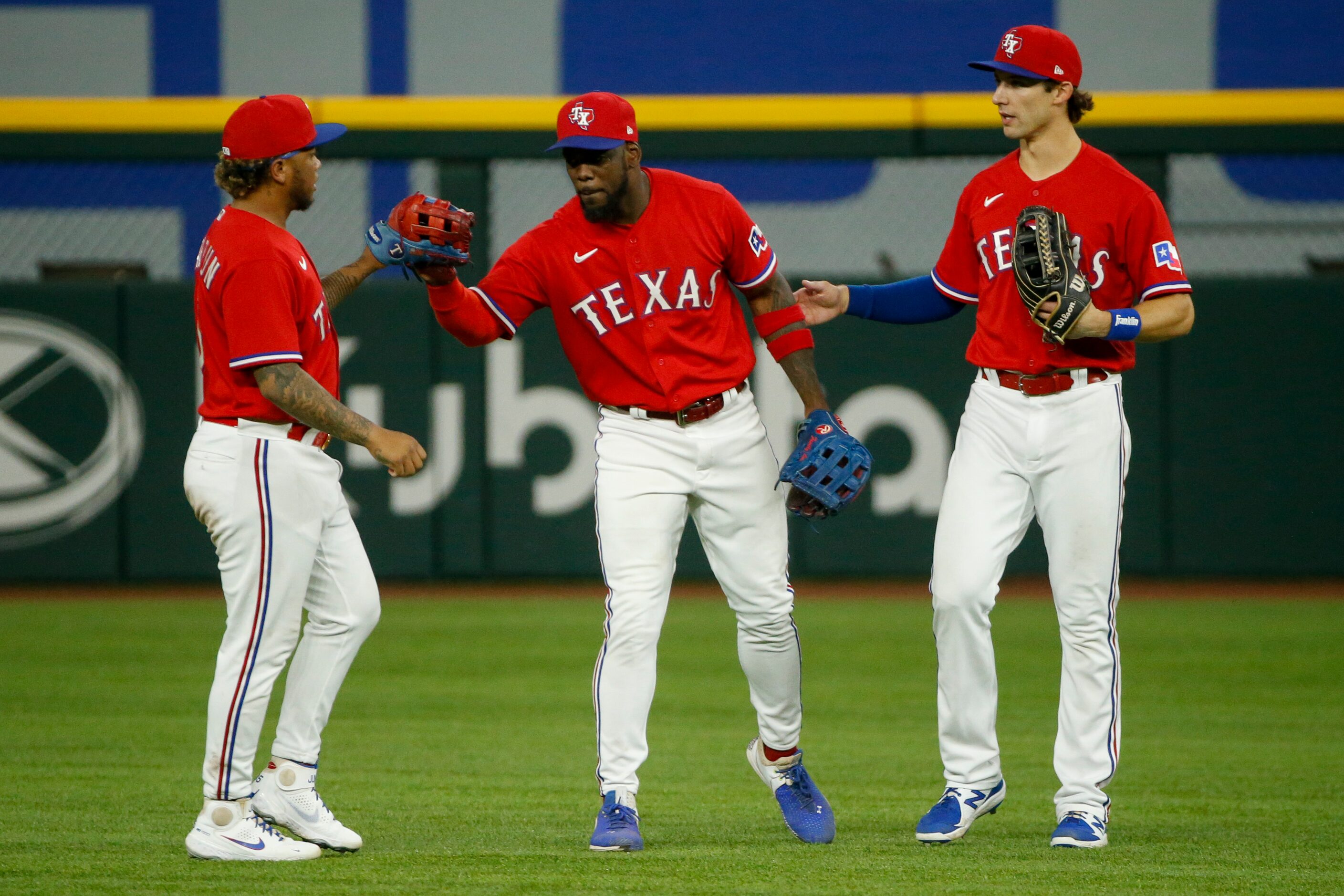 From left, Texas Rangers left fielder Willie Calhoun (5), Texas Rangers center fielder...