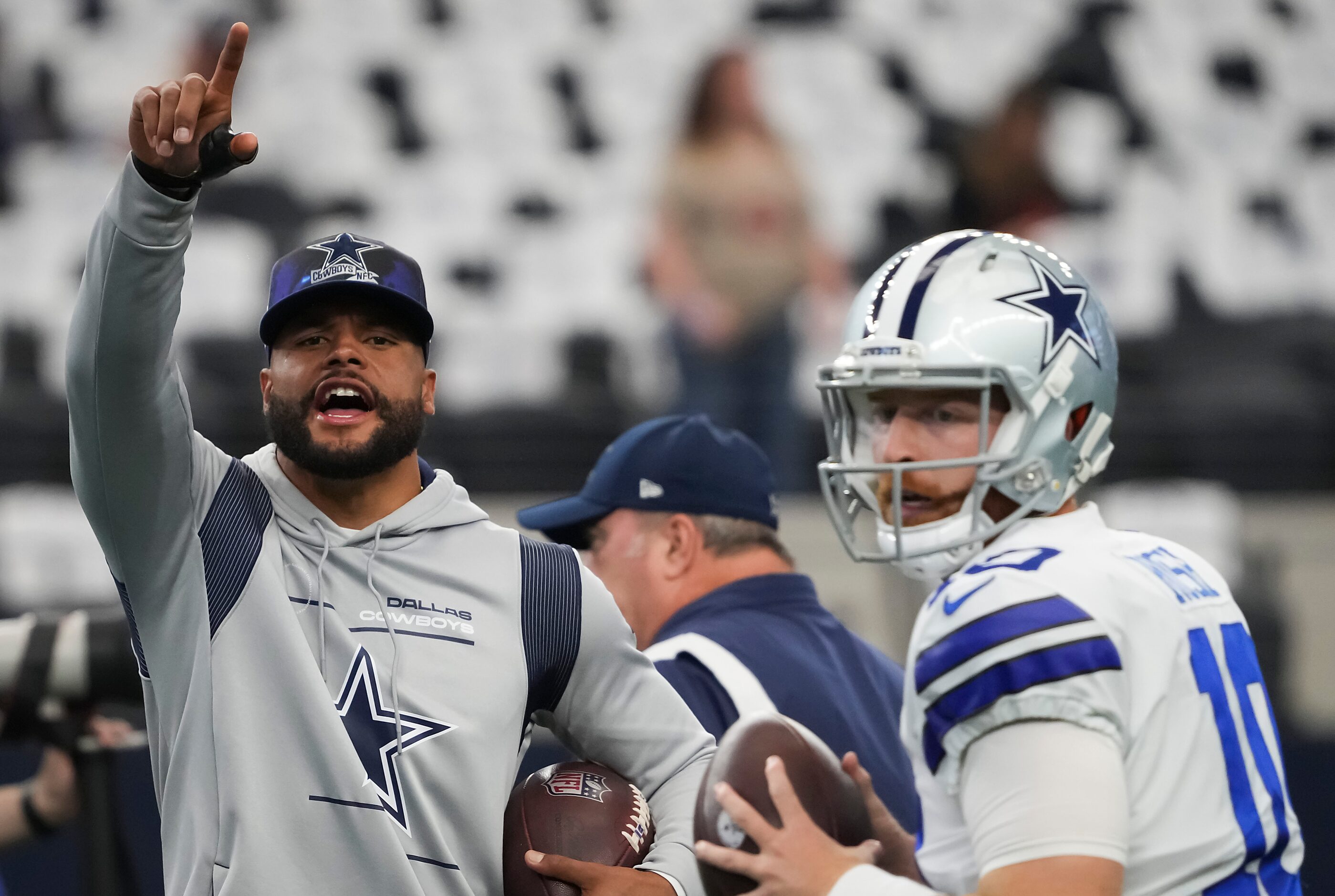 Dallas Cowboys quarterback Dak Prescott (left) shouts encouragement to his teammates as...