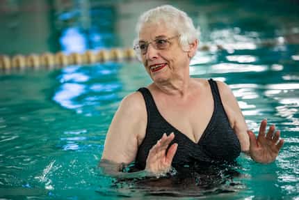 Miriam Cohen pushes water with her arms during her swimming exercise class at the Texas...