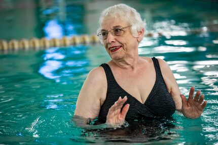 Miriam Cohen pushes water with her arms during her swimming exercise class at the Texas...