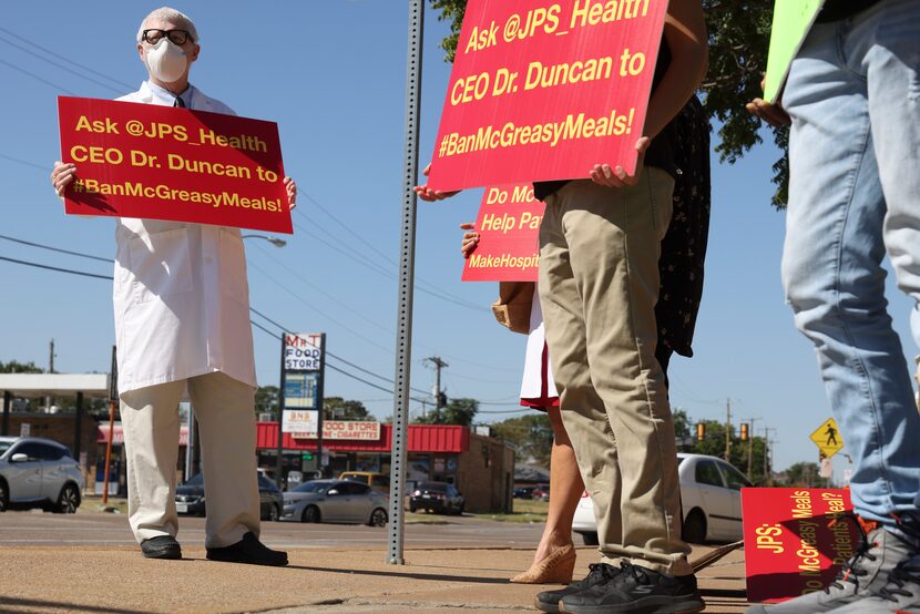 Dr. John Pippin and others gather to protest against the McDonalds inside John Peter Smith...