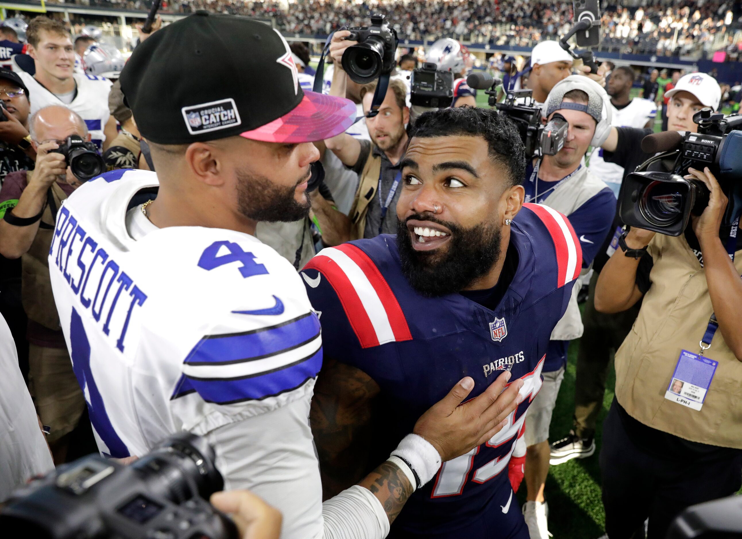 Dallas Cowboys quarterback Dak Prescott (4) and New England Patriots running back Ezekiel...