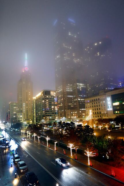 Fog settled over the historic Mercantile Building (left) and Comerica Bank Tower (center)...