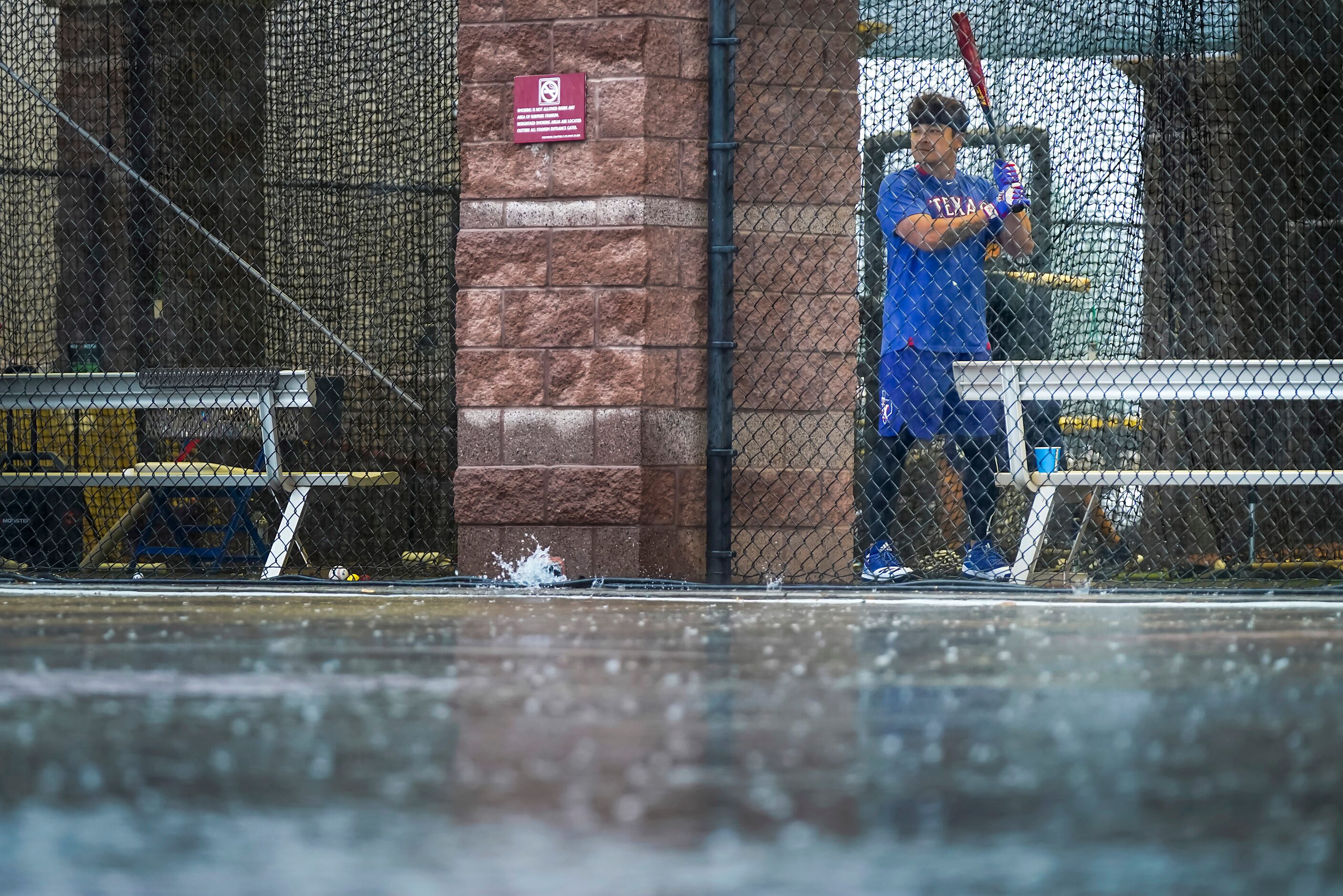 Texas Rangers outfielder Shin-Soo Choo takes a practice swing in the indoor batting cage as...