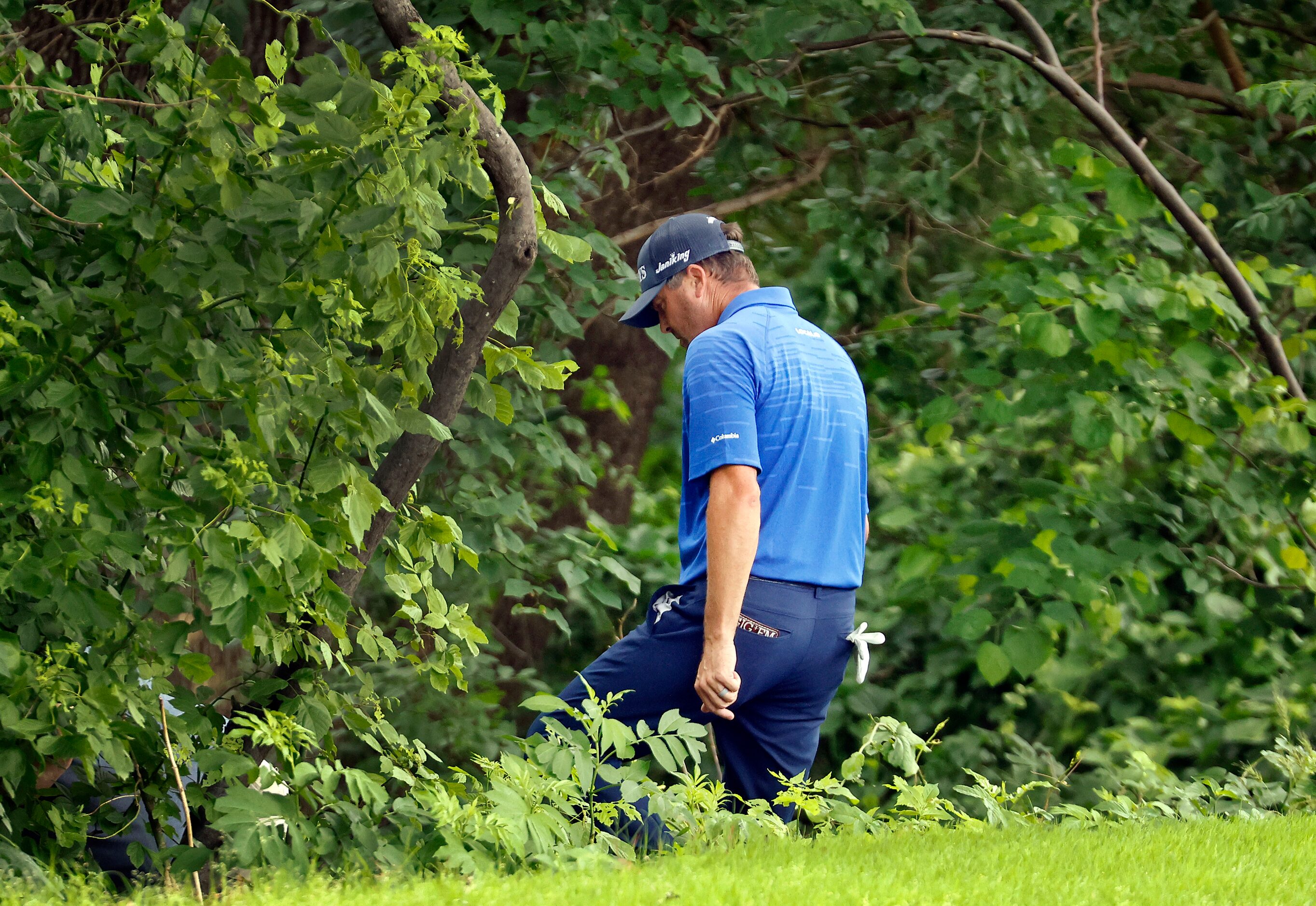 Professional golfer Ryan Palmer looks for his approach shot along the Trinity River on No. 5...