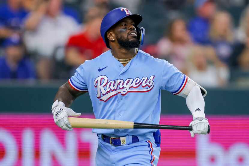 Texas Rangers' Adolis Garcia reacts after striking out in the third inning of a baseball...