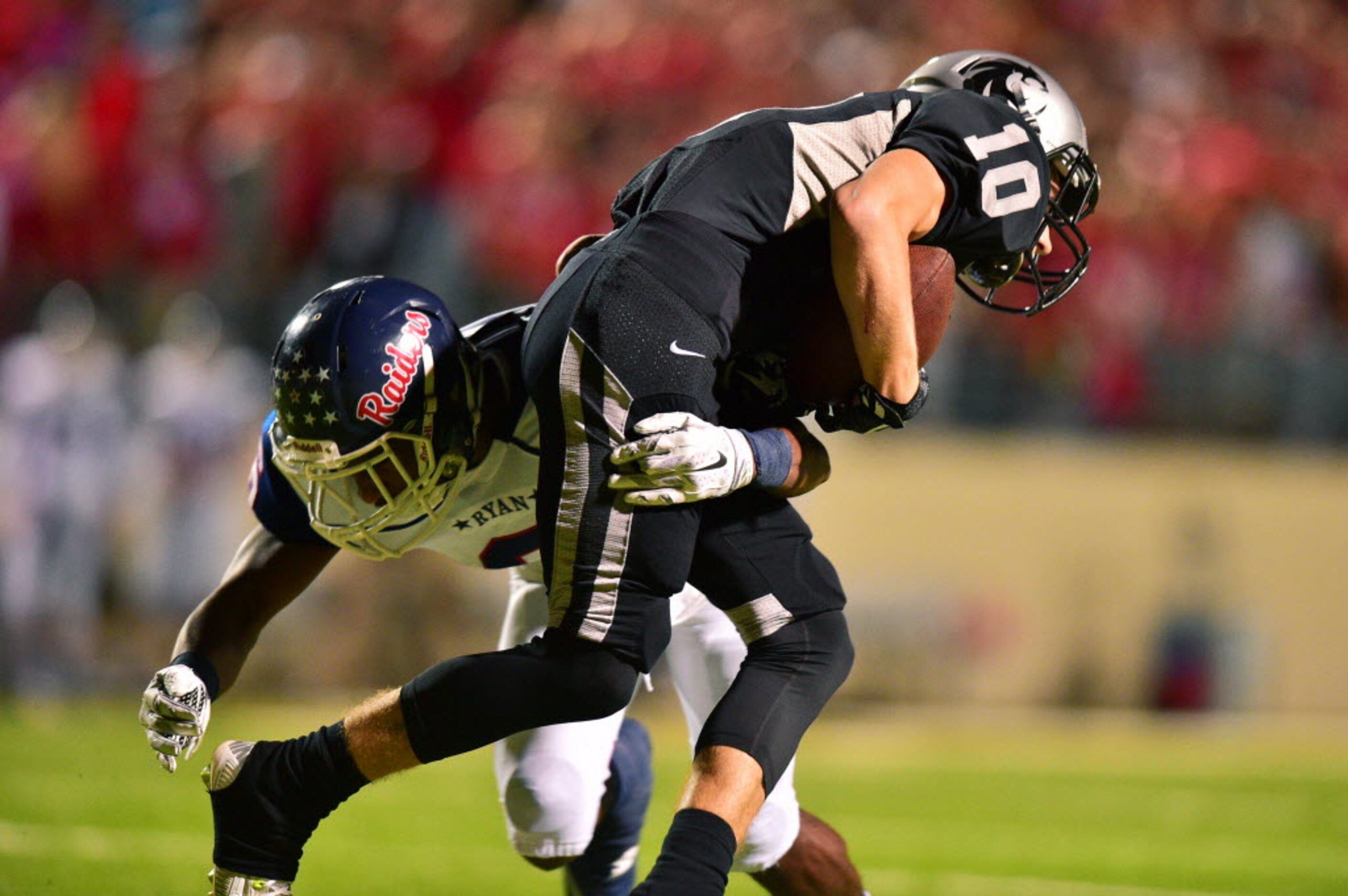 Guyer sophomore wide receiver Colton Phillips (10) is wrapped up by Ryan sophomore defensive...